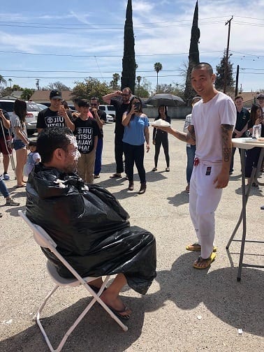 Raffle winner David Yu is about to throw a pie in Professor Gino's face at the 1 year anniversary in San Gabriel