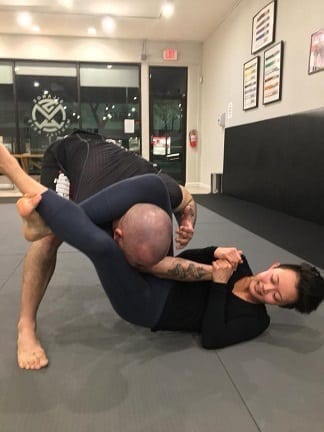 Jiu-Jitsu student Rebecca applying a Triangle Choke