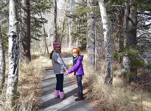 Jiu-Jitsu student Emma walking in a forest with a cousin
