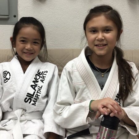 Emma and Alison from the BJJ kids program on the couch
