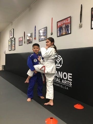 Emma and Kyle working on their Jiu-Jitsu Single leg takedown technique