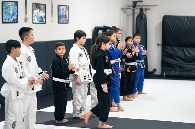 Jaelen in a group picture at the Silanoe Martial Arts belt promotion ceremony together some of his Kids 2 teammates.