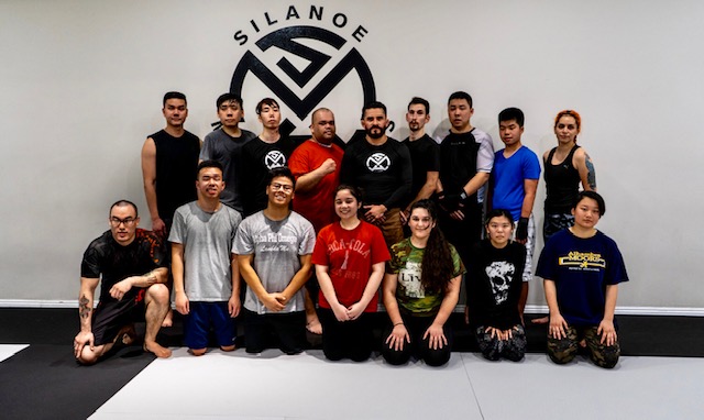 Joe Hernandez in the red shirt in a Group Picture with Muay Thai Kickboxing teammates