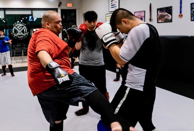 Joe, Jack and Will training together in the Muay Thai Kickboxing class working on their low kick.