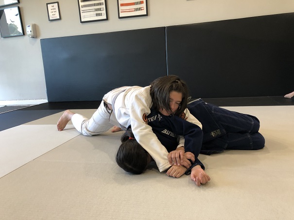 Sasha Gracia attacking the armbar of the kimura grip on partner Emma in the BJJ Kids 2 San Gabriel Alhambra.