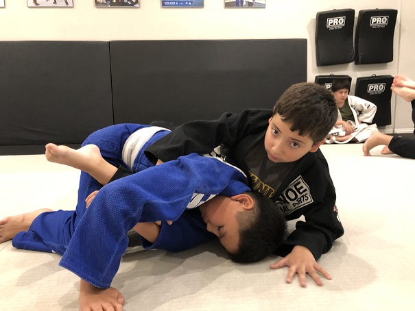 Nicholas Kid Jiu-Jitsu student of the month is attacking his training partner Kyle from the BJJ closed guard.