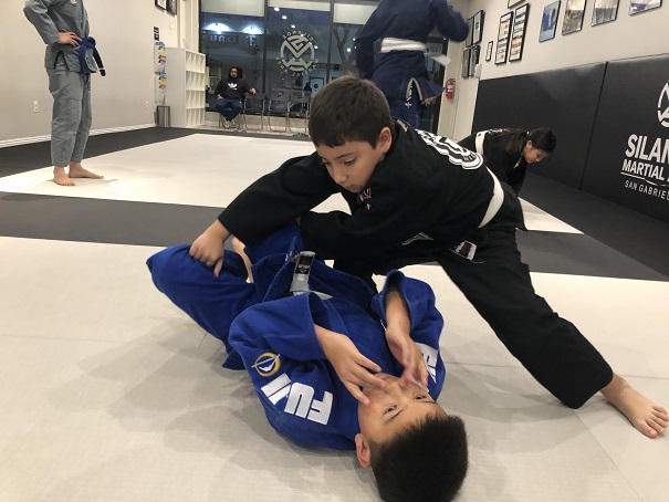 Nicholas initiating the Torreando Bull fighter guard pass on Kyle H. earning him the 3 guard passing points in our Kids Self-Defense program at Silanoe San Gabriel.