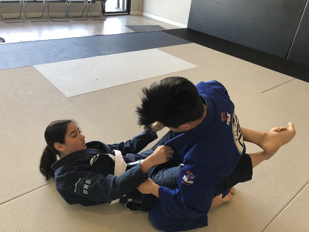 Ally fighting for grips on her opponent Ethan P. at the Saturday 11 AM class at Silanoe San Gabriel Alhambra San Marino Rosemead.