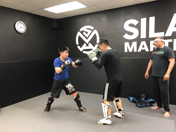 Caleb sparring on the rear mat at Silanoe Martial Arts during the Muay Thai Dutch Kickboxing class in San Gabriel Alhambra academy.