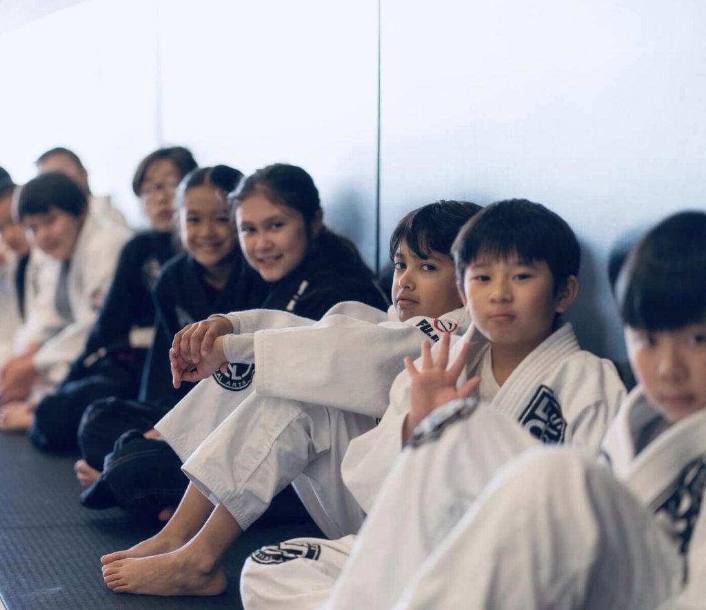 Charles K. and brother Alex K. in the picture wearing white gis. Both are on the right side of the picture ready start Saturday BJJ class at Silanoe. 