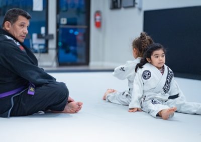 Coach Chris teaching Lola and Chelsea of Kids 1 Martial Arts BJJ Program ages 5-8