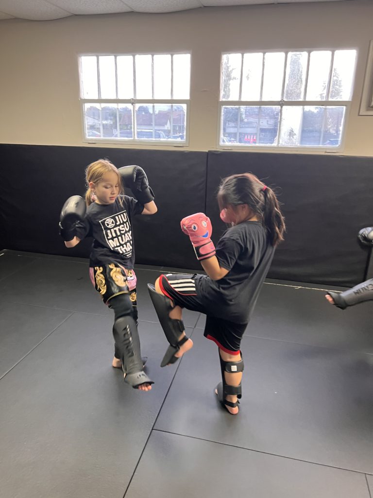 Kids learn to check leg kicks and other techniques in Muay Thai Kickboxing