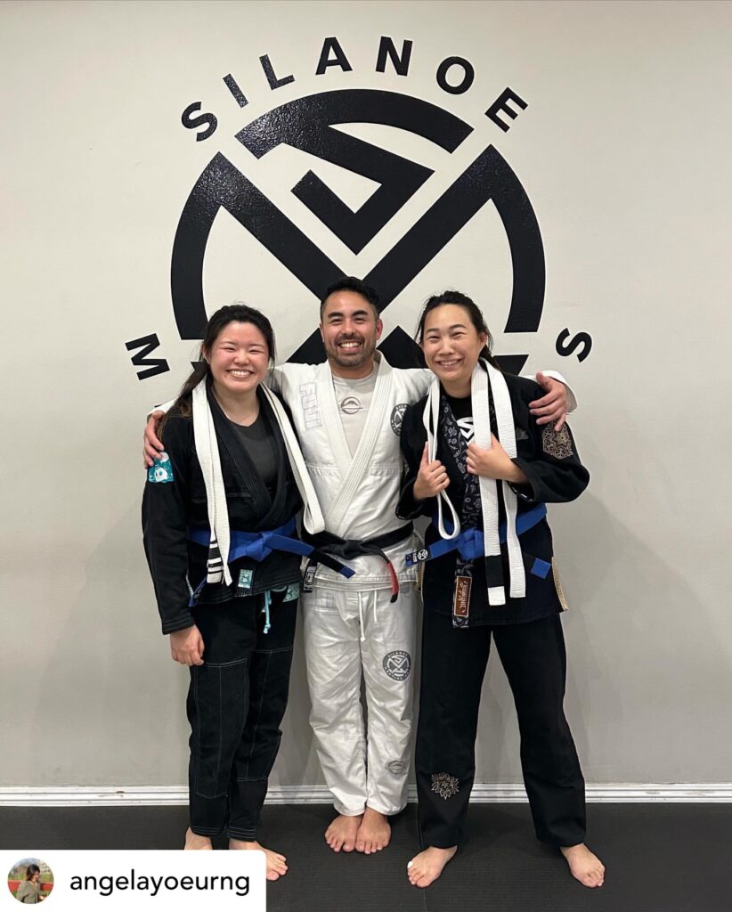 Prof Gino, Timony, and Angela at their BJJ Blue Belt ceremony